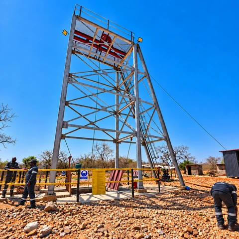 Steel shaft headgear above a fenced shaft area at Anzac Antimony Mine.