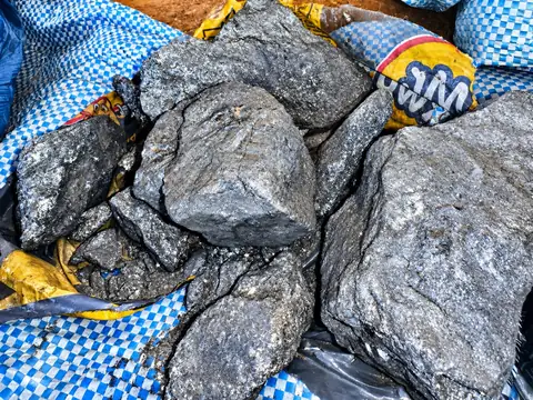 Close view of silver-grey material samples arranged on woven sacks.