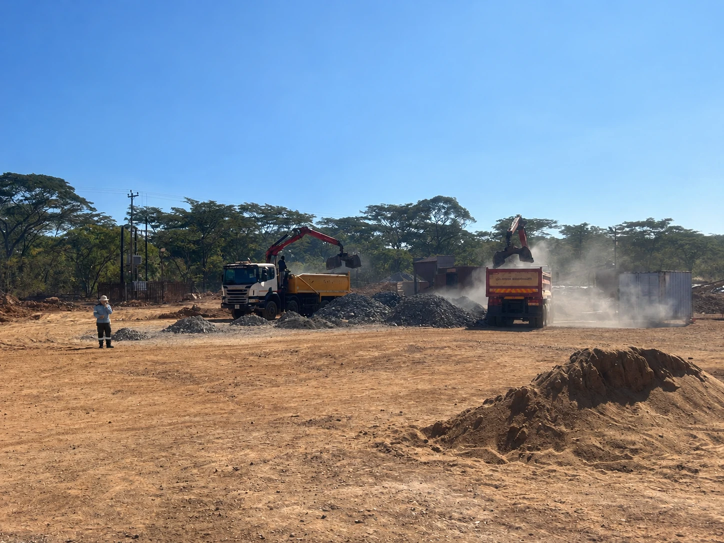 Trucks at the stockyard with a person in AGANO managerial workwear